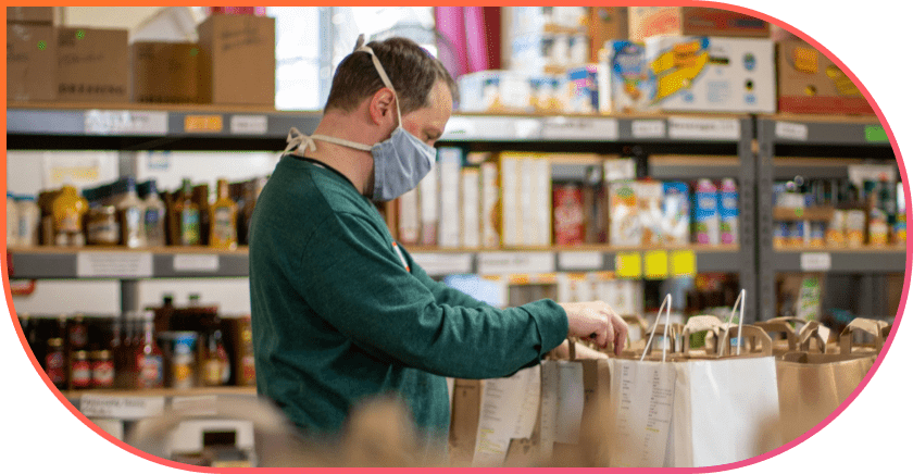 A person in a mask works on something.